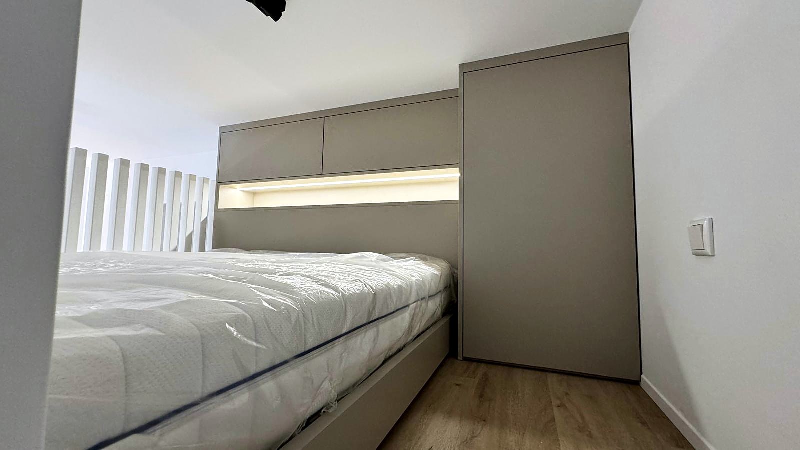Ein-Raum-Apartment Berlin von HOME Schlafen & Wohnen: Bett auf der Galerie mit Lichtleiste