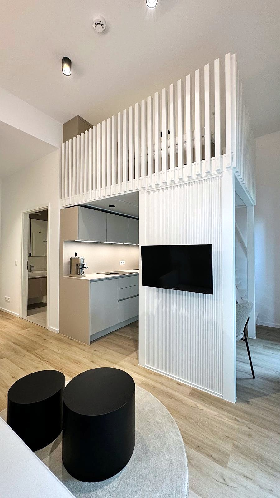 Ein-Raum-Apartment Berlin von HOME Schlafen & Wohnen: Küchennische mit Medienwand